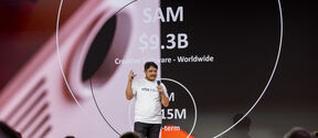 A founder pitching his project on stage in fron of an audience