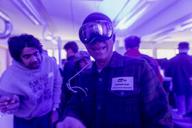 A person with VR glasses looking at the camera at Demo Day 2025