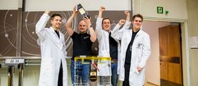 Janne Kuhno, Jaan Praks, Antti Kestilä, and Tuomas Tikka celebrate the completion of the satellite. Photo: Mikko Raskinen / Aalto University