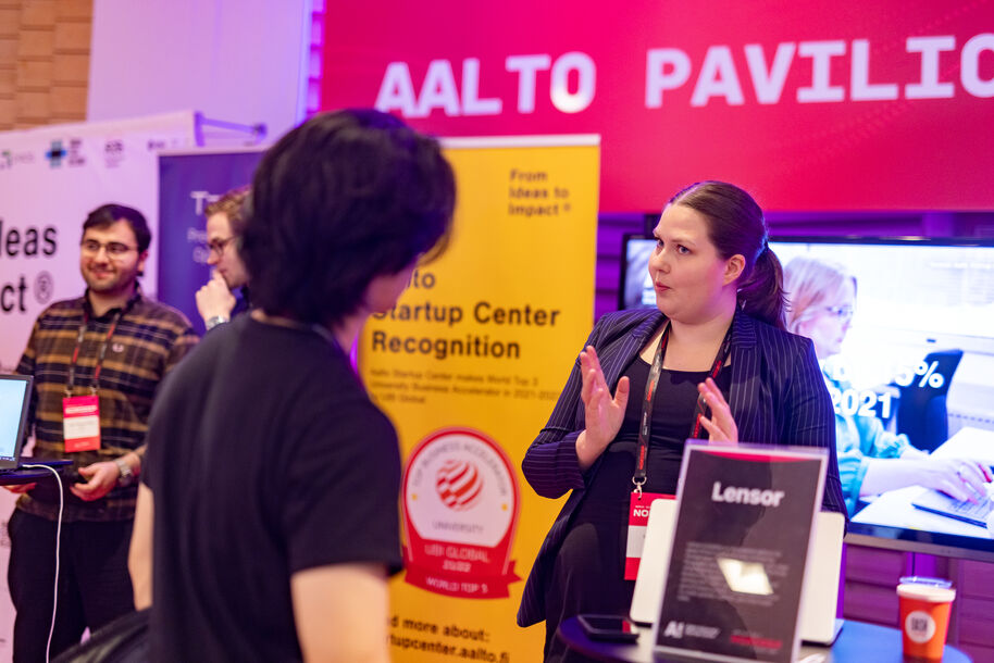 Lisa from Lensor explaining to an event attendee what her copany does