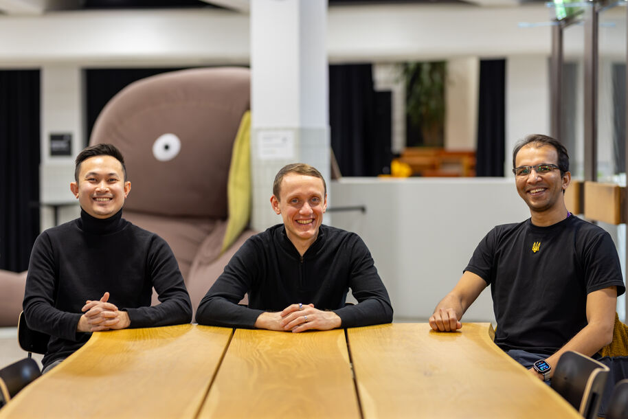 The Proteins.1 team sitting and smiling at the camera